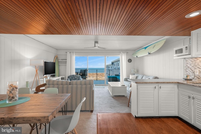 kitchen featuring ceiling fan, white cabinetry, backsplash, and wood ceiling