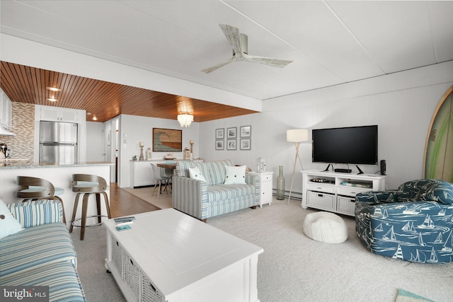 living room featuring ceiling fan, wooden ceiling, light carpet, and a baseboard heating unit