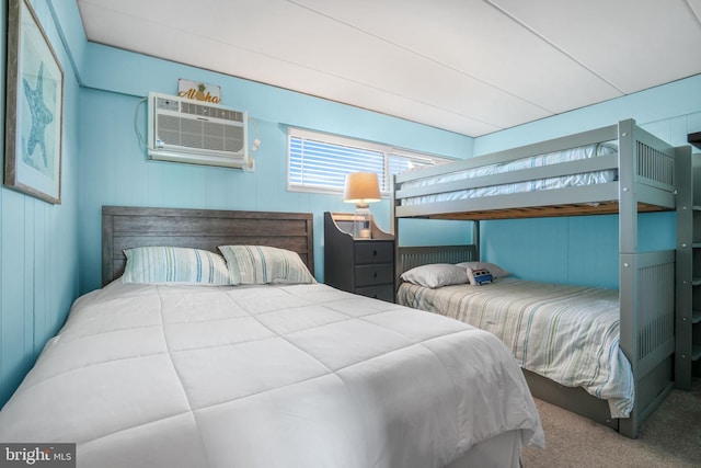 bedroom with carpet flooring and a wall unit AC