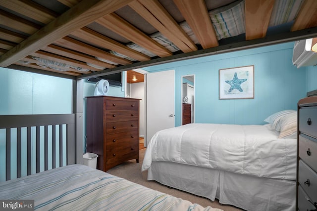 bedroom featuring beamed ceiling and light colored carpet