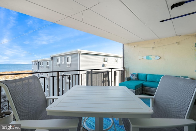 balcony featuring a water view and a view of the beach