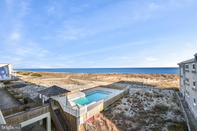 view of swimming pool featuring a water view