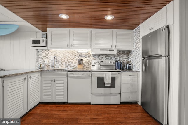 kitchen with custom exhaust hood, white appliances, dark wood-type flooring, sink, and white cabinetry