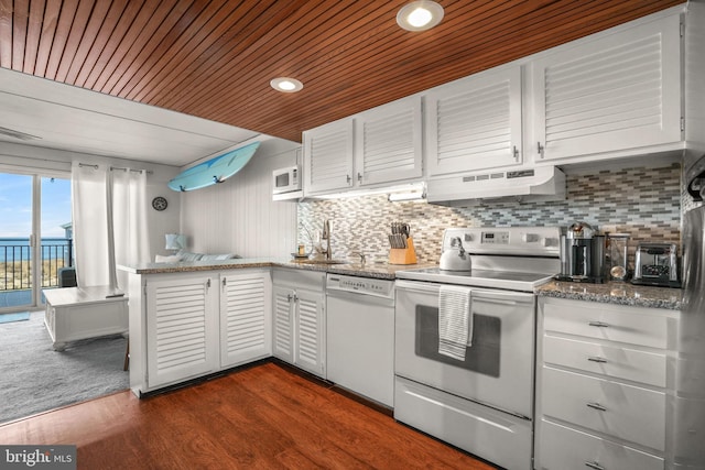 kitchen with white cabinetry, white appliances, dark wood-type flooring, and range hood