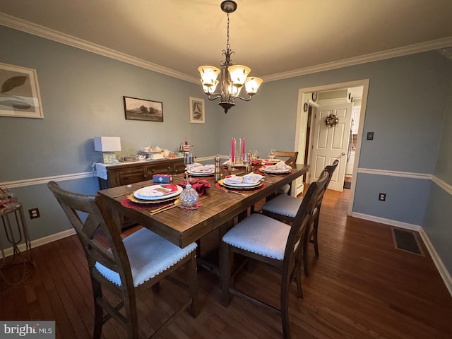 dining area featuring a chandelier, ornamental molding, and dark wood-type flooring