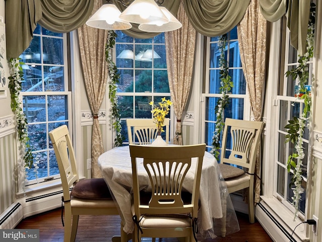 dining space with dark hardwood / wood-style floors and a baseboard radiator