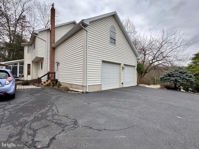 view of side of home featuring a garage