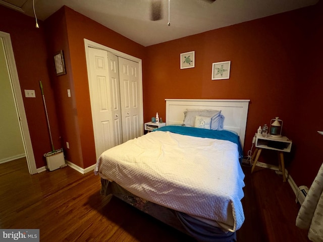 bedroom featuring ceiling fan, a closet, and dark wood-type flooring