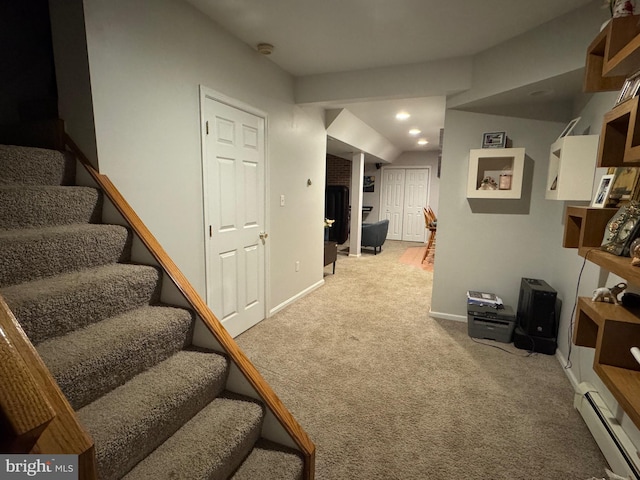 interior space featuring light colored carpet and a baseboard radiator