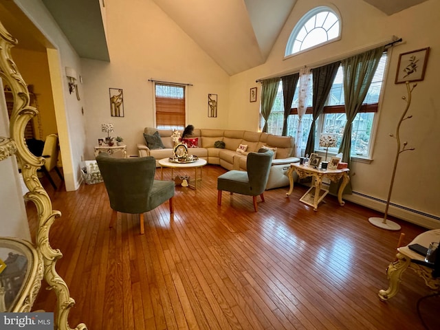 living room featuring wood-type flooring, a baseboard radiator, and high vaulted ceiling