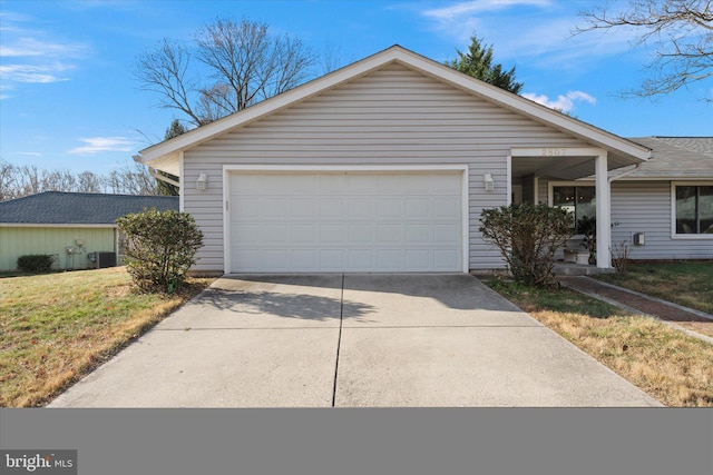 view of front of property with a front yard, a garage, and central AC unit