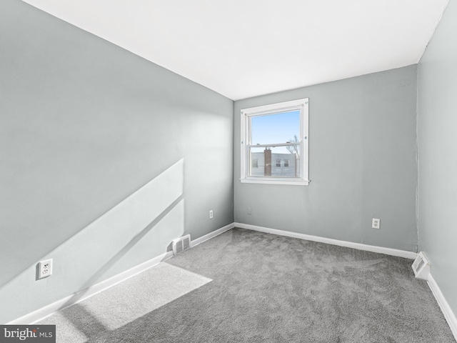 empty room with carpet and vaulted ceiling