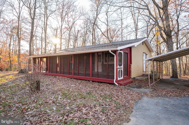 exterior space with a sunroom and a carport