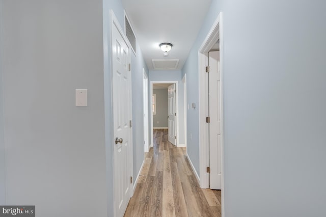 corridor with light wood-type flooring