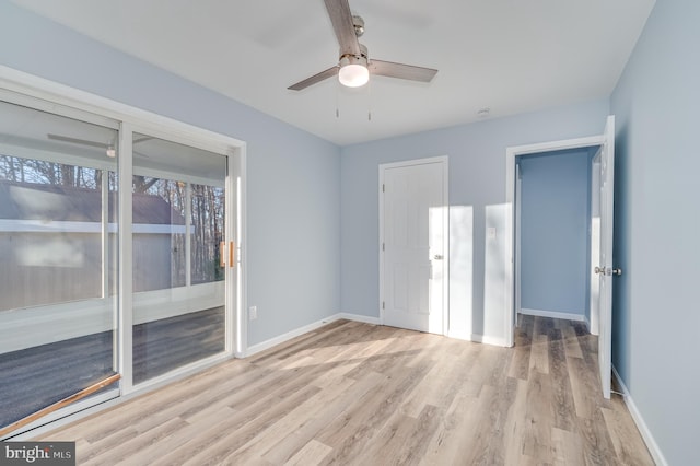 empty room with ceiling fan and light hardwood / wood-style floors