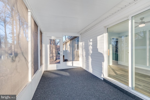 unfurnished sunroom featuring ceiling fan