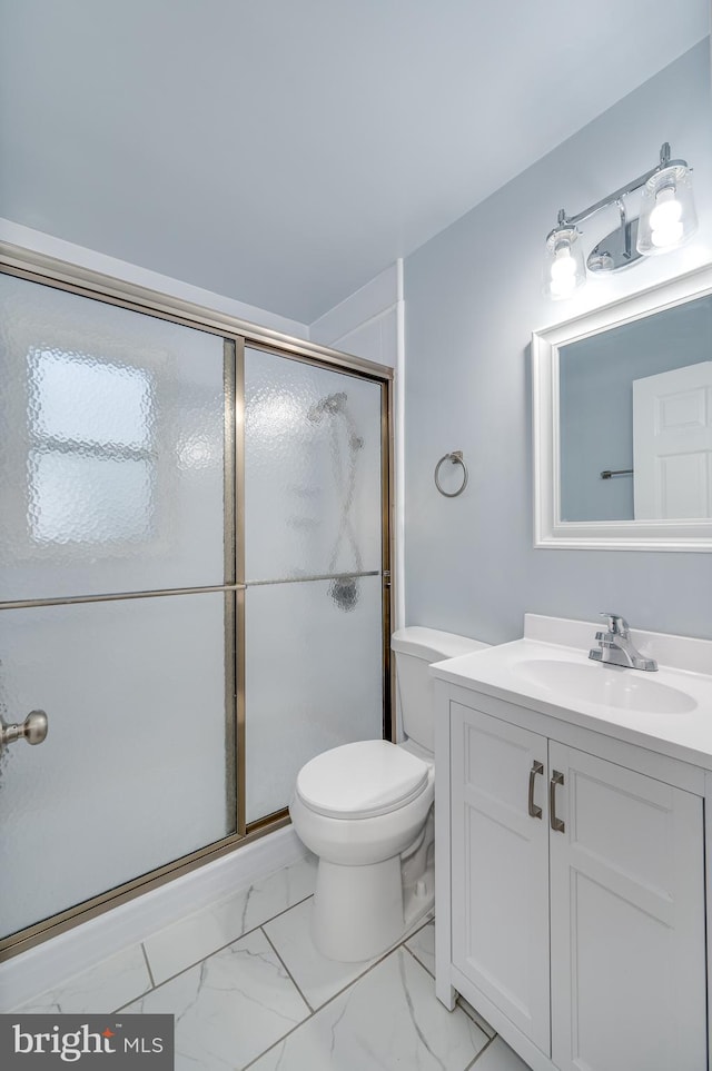 bathroom with vanity, toilet, and an enclosed shower