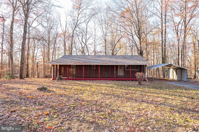 view of front of house featuring a carport and a sunroom