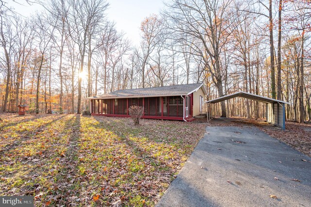 view of front of house with a sunroom and a carport