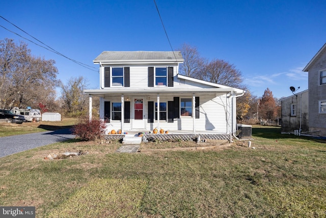 view of front of property with a porch, central AC, and a front lawn