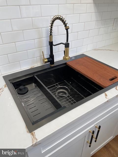 details featuring dark hardwood / wood-style floors and sink