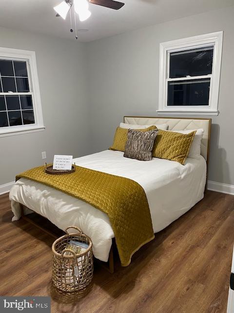 bedroom featuring ceiling fan and dark wood-type flooring