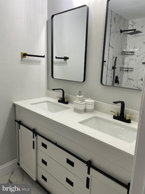 bathroom with vanity and a tile shower