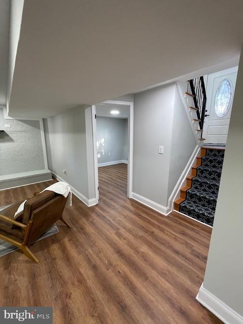 basement with dark hardwood / wood-style floors