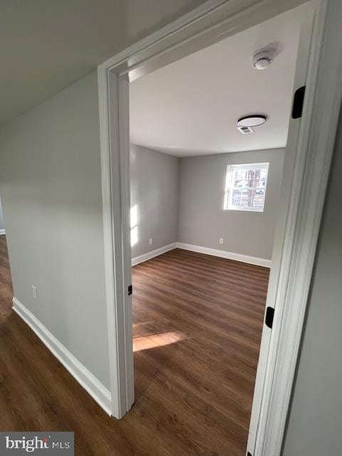 bonus room with dark hardwood / wood-style flooring