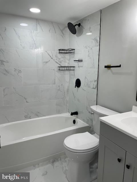 full bathroom with vanity, tiled shower / bath combo, and toilet