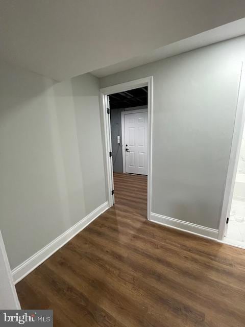 hallway featuring dark hardwood / wood-style flooring