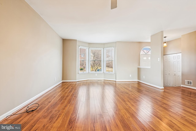 empty room with hardwood / wood-style floors