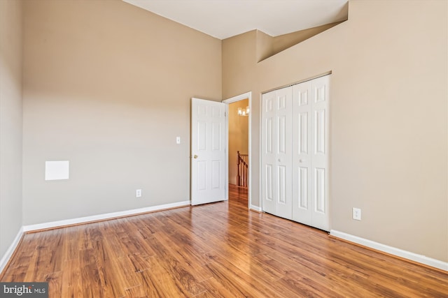 unfurnished bedroom featuring hardwood / wood-style flooring and a closet