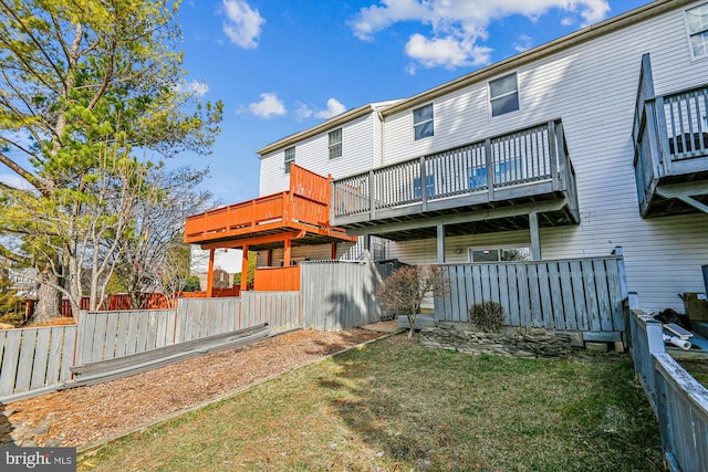 rear view of property featuring a lawn