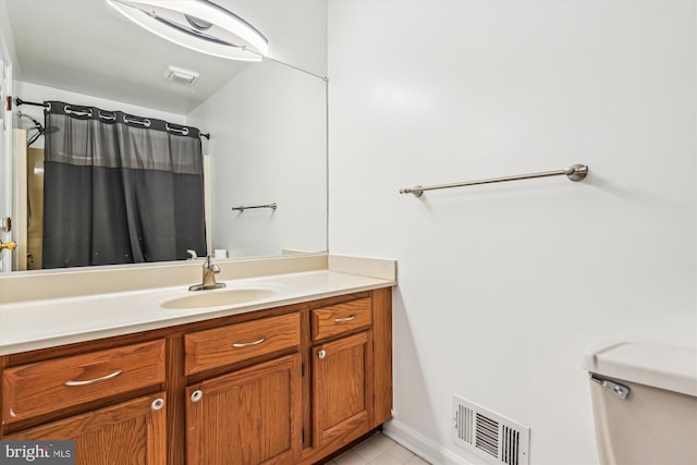 bathroom with vanity, tile patterned floors, and toilet