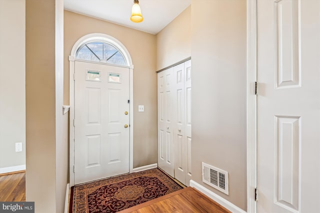 entryway with hardwood / wood-style floors