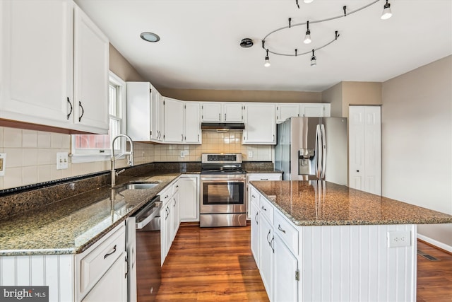 kitchen featuring white cabinetry, sink, dark stone counters, and appliances with stainless steel finishes