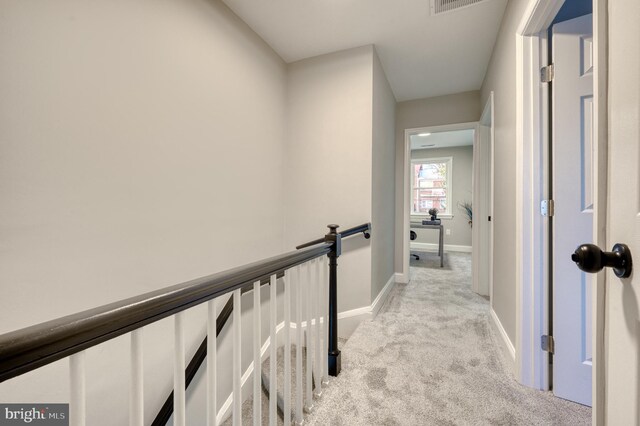 hall featuring light colored carpet