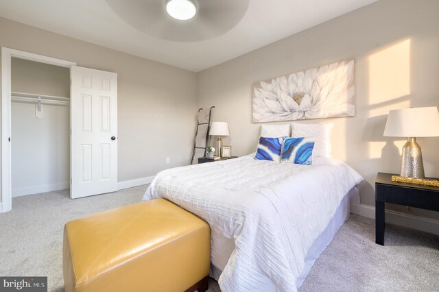 carpeted bedroom featuring ceiling fan and a closet