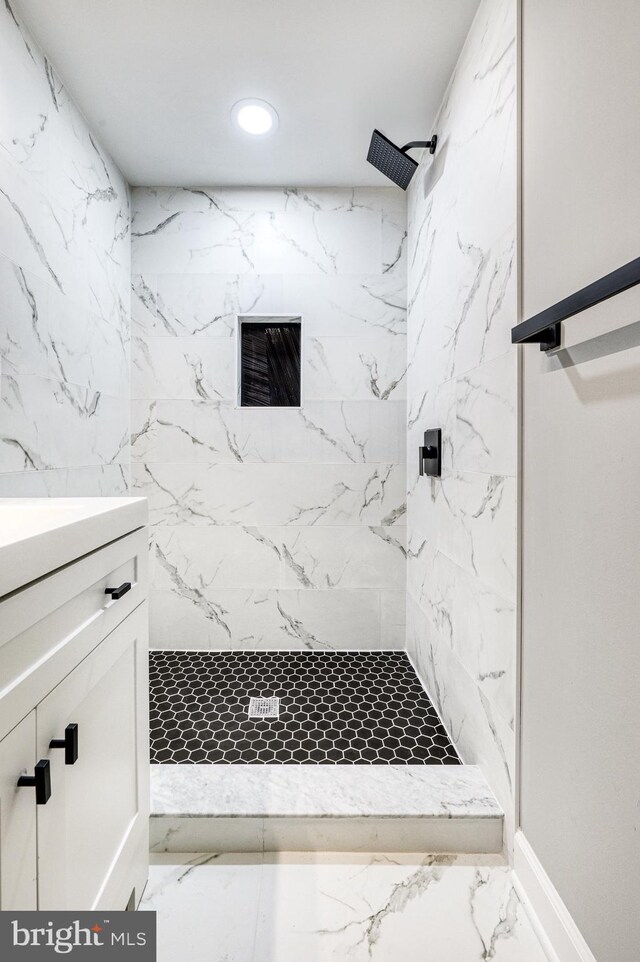 bathroom featuring vanity and tiled shower