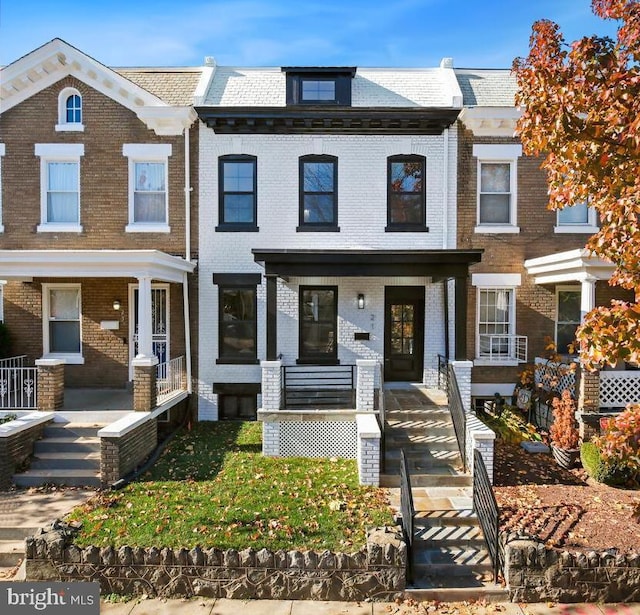 townhome / multi-family property with covered porch