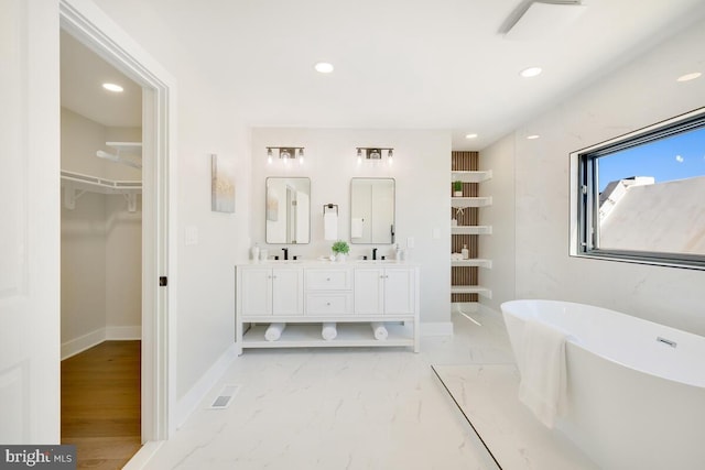 bathroom featuring a bath and vanity