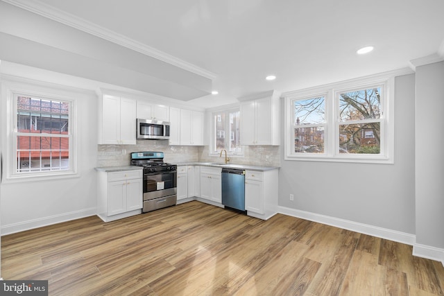 kitchen with white cabinetry, a healthy amount of sunlight, and appliances with stainless steel finishes