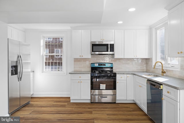 kitchen with white cabinetry, stainless steel appliances, and dark wood-type flooring