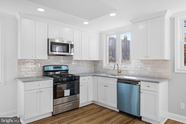 kitchen with sink, white cabinetry, and stainless steel appliances