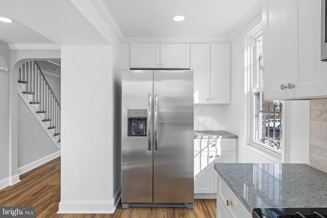 kitchen with hardwood / wood-style flooring, white cabinetry, and stainless steel fridge with ice dispenser