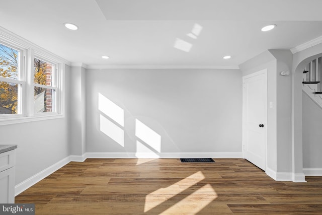 unfurnished room featuring dark hardwood / wood-style floors and ornamental molding