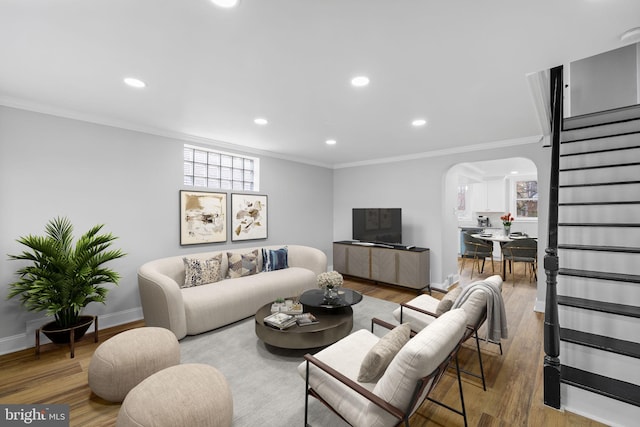 living room with hardwood / wood-style floors and crown molding