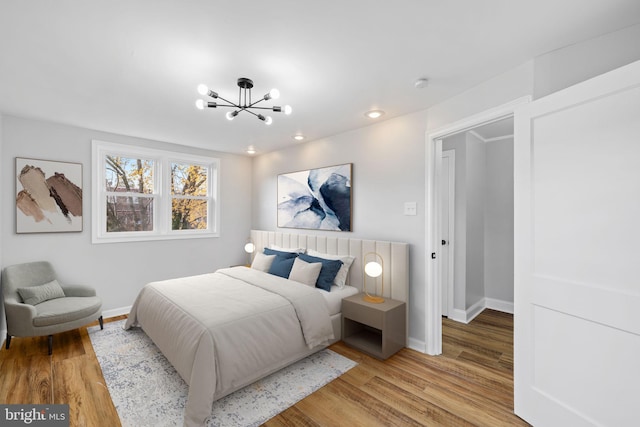 bedroom featuring light hardwood / wood-style flooring and a notable chandelier