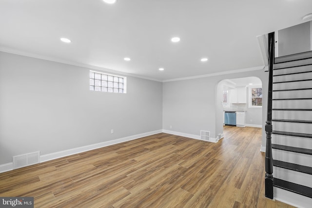 basement with wood-type flooring and ornamental molding